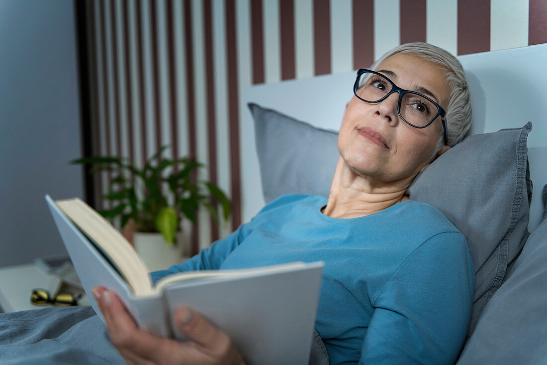 Woman reading in bed