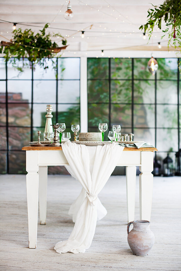 Festively set country-house table in industrial building