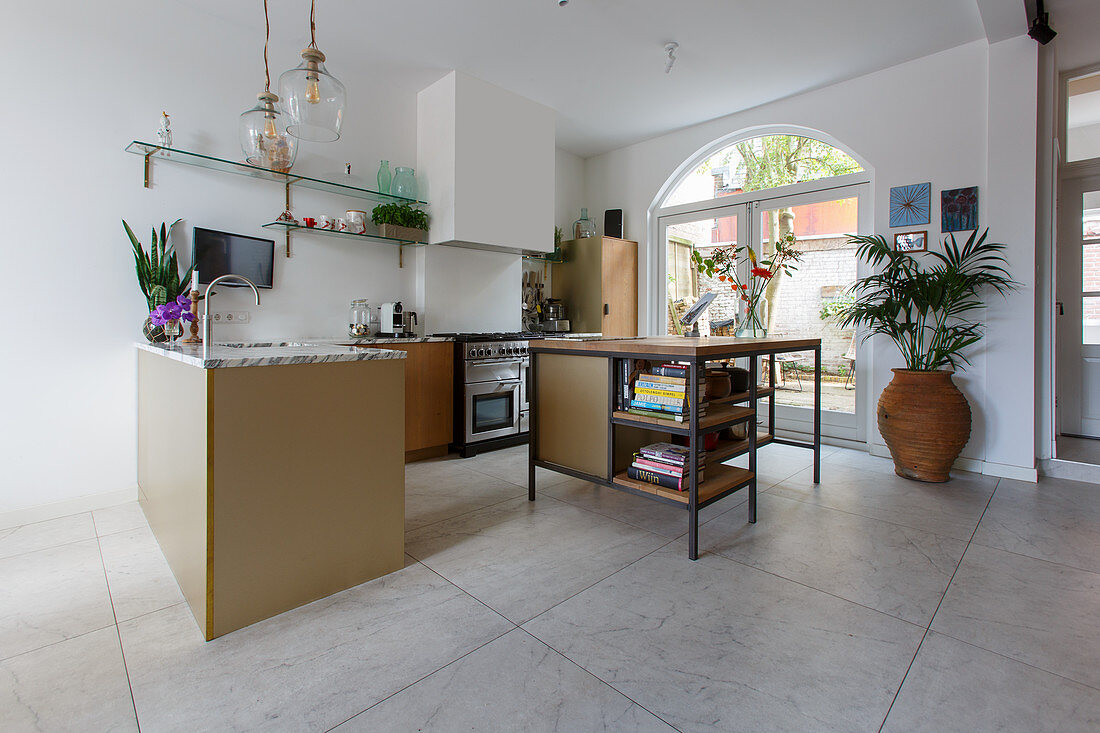 Island counter in open-plan kitchen with large floor tiles