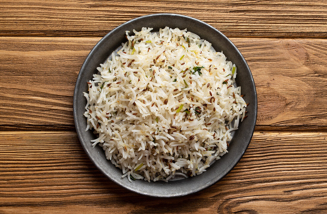 Indian boiled biryani rice with salad with cumin