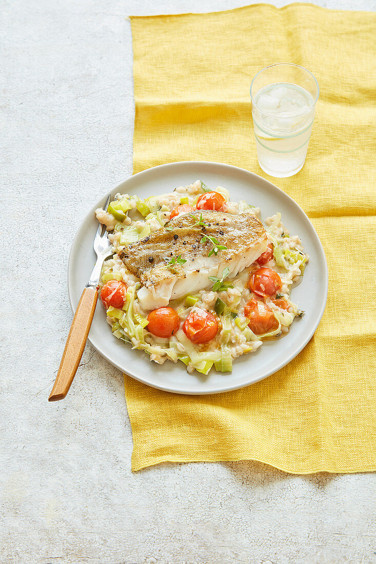 Leek, tomato and barley risotto with pan-fried cod