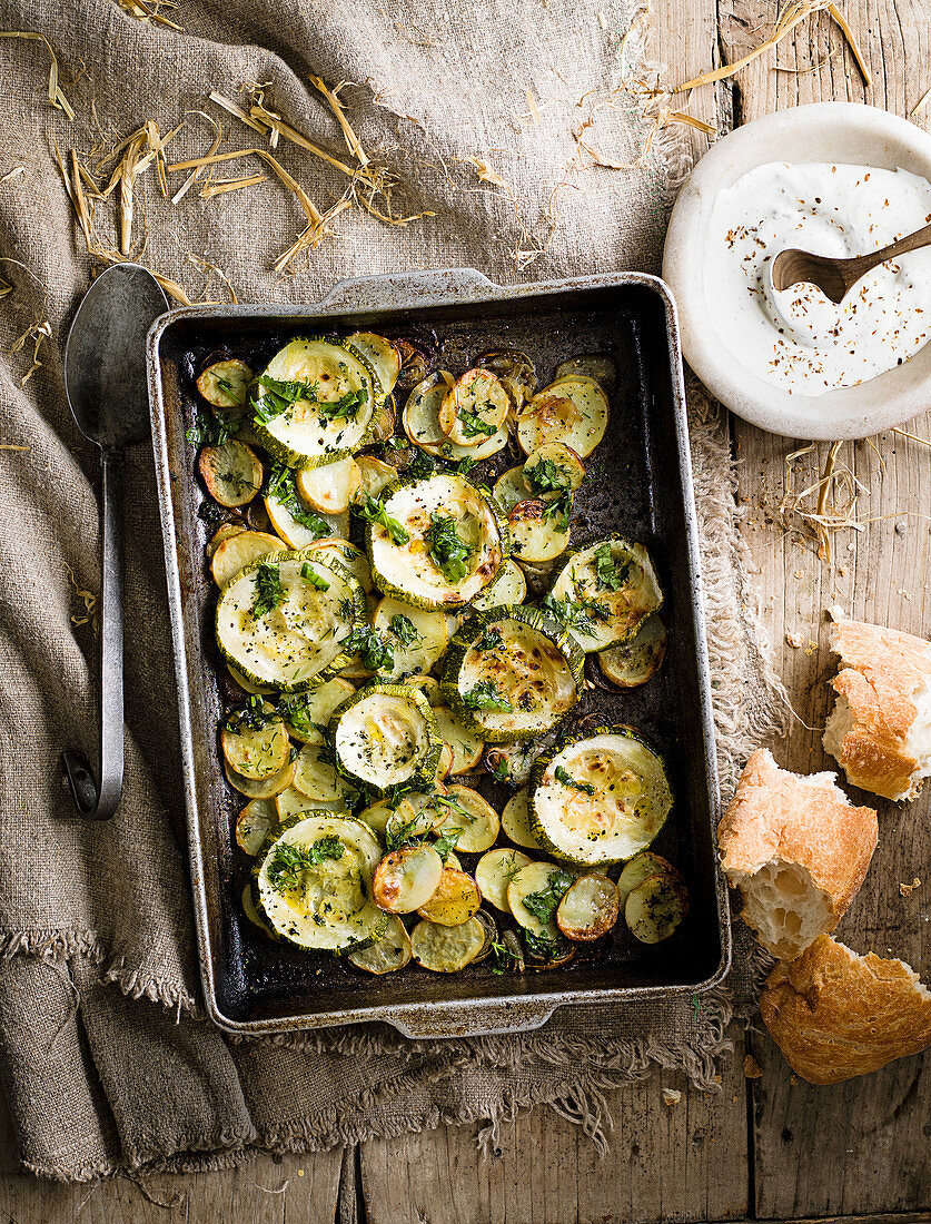 Courgette, potato and shallot bake with mashed garlic and soft herbs