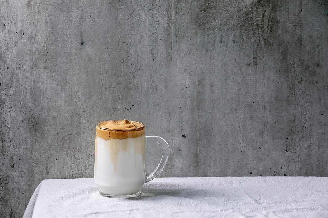 Dalgona frothy coffee (trend korean drink) - milk latte with coffee foam in glass mug