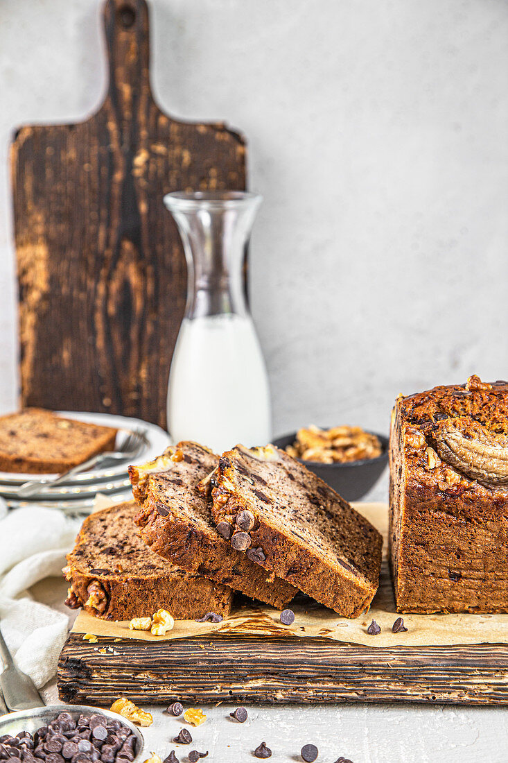 Banana bread with chocolate and walnuts, on a wooden board