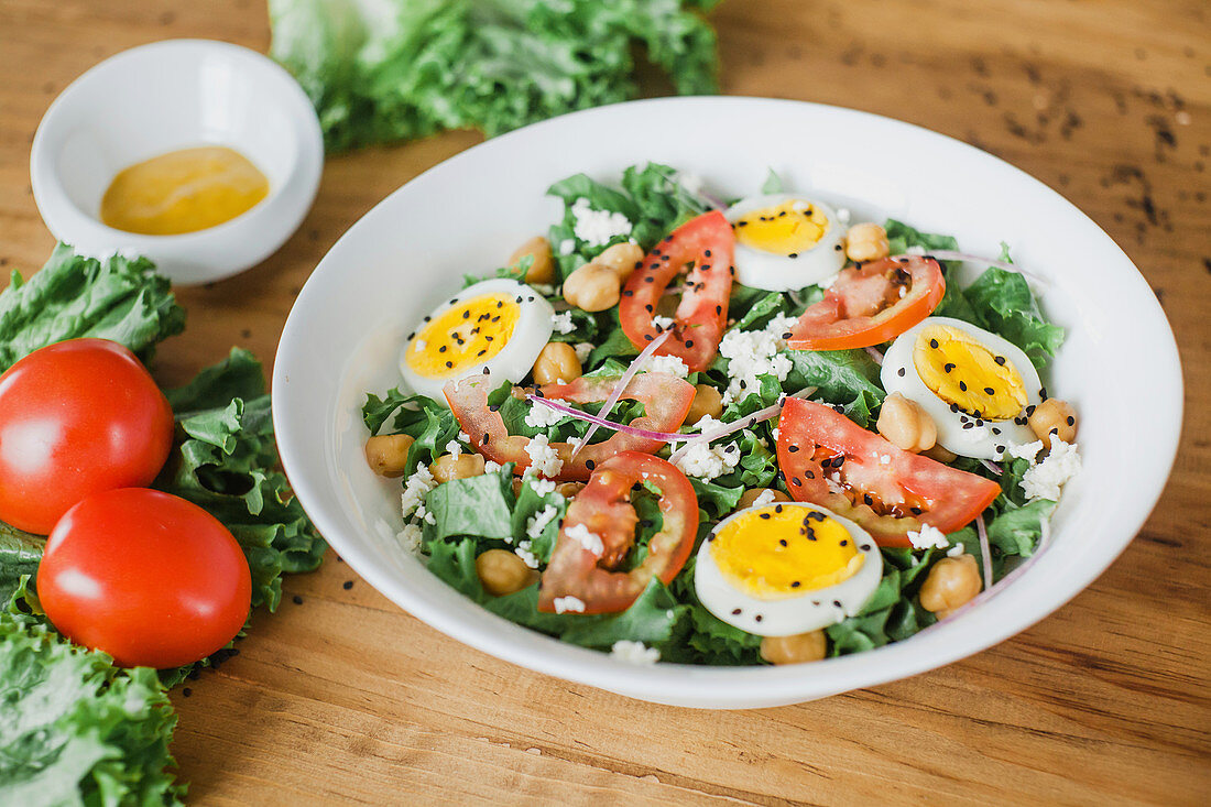 Tomato and lettuce salad with chickpeas and boiled eggs