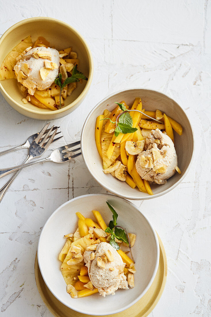 Cashew nut and banana ice cream with a mango and pineapple salad and chillis