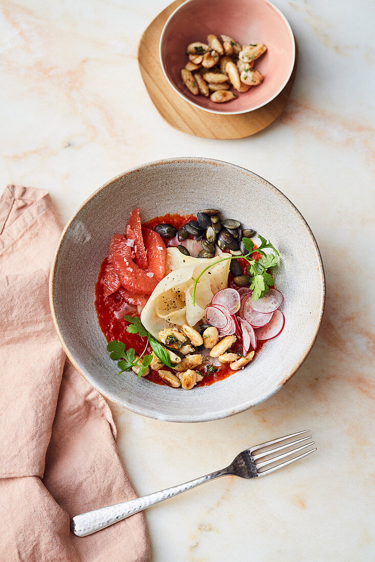 Celeriac with almonds, radishes, pink grapefruit and pepper sauce