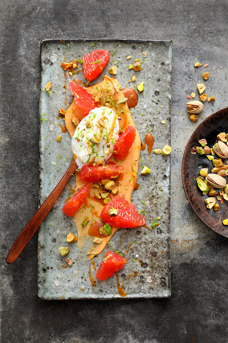 Grapefruit with lime yoghurt and pistachio nuts on toffee cream