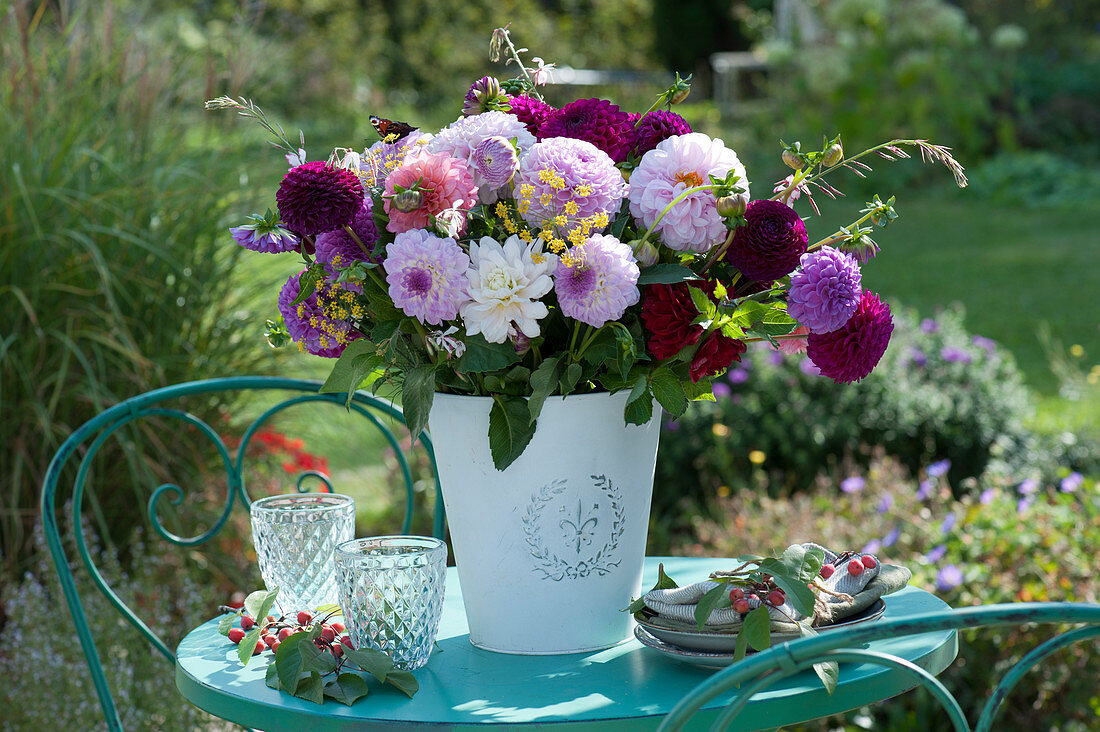 Bouquet of dahlias, fennel umbels and a Lindheimer's beeblossom with peacock butterfly, malus prunifolia branches