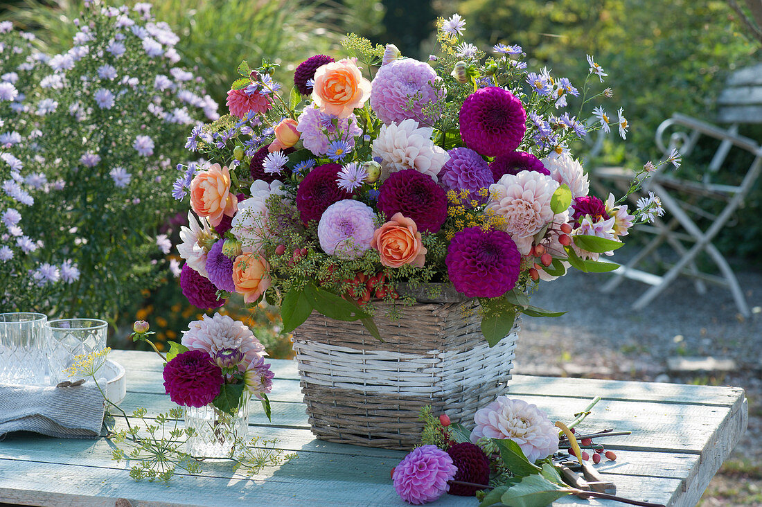 Lush autumn bouquet with dahlias, roses, asters, fennel umbels and malus prunifolia in the basket