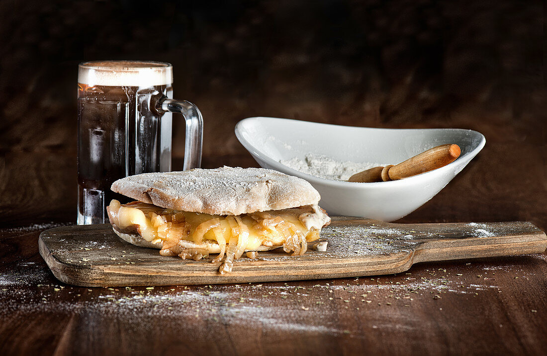Traditional Spanish sandwich made with Iberian pork loin and cheese with fried onion