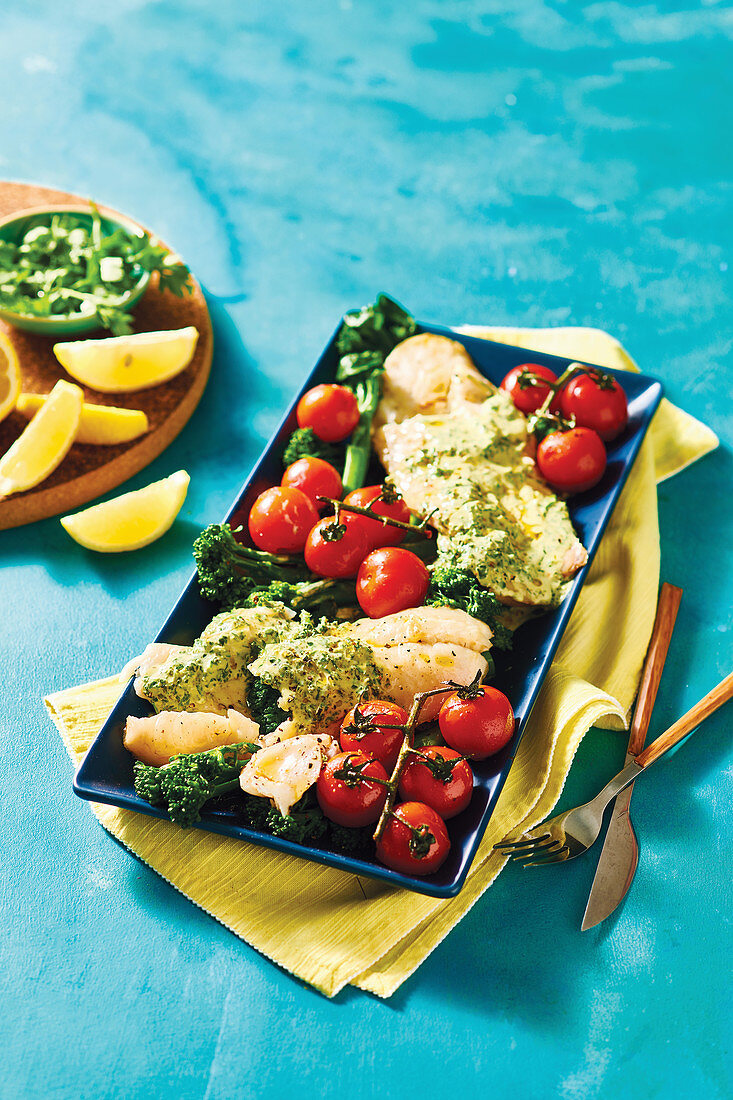 Baked hake with parsley sauce and roasted tomatoes