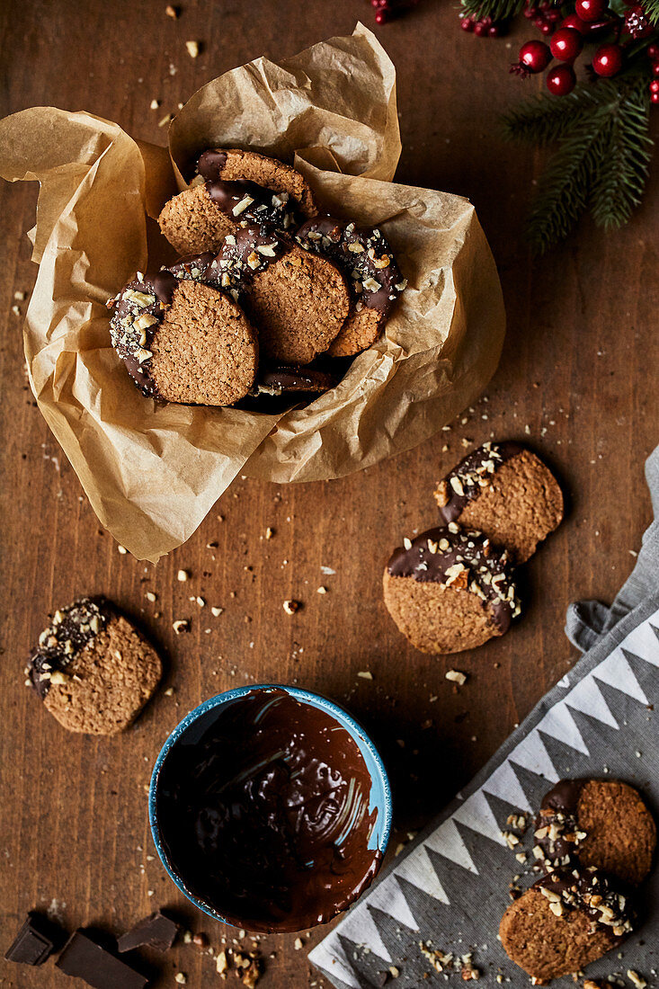 Winter cookies with walnuts dipped in melted chocolate