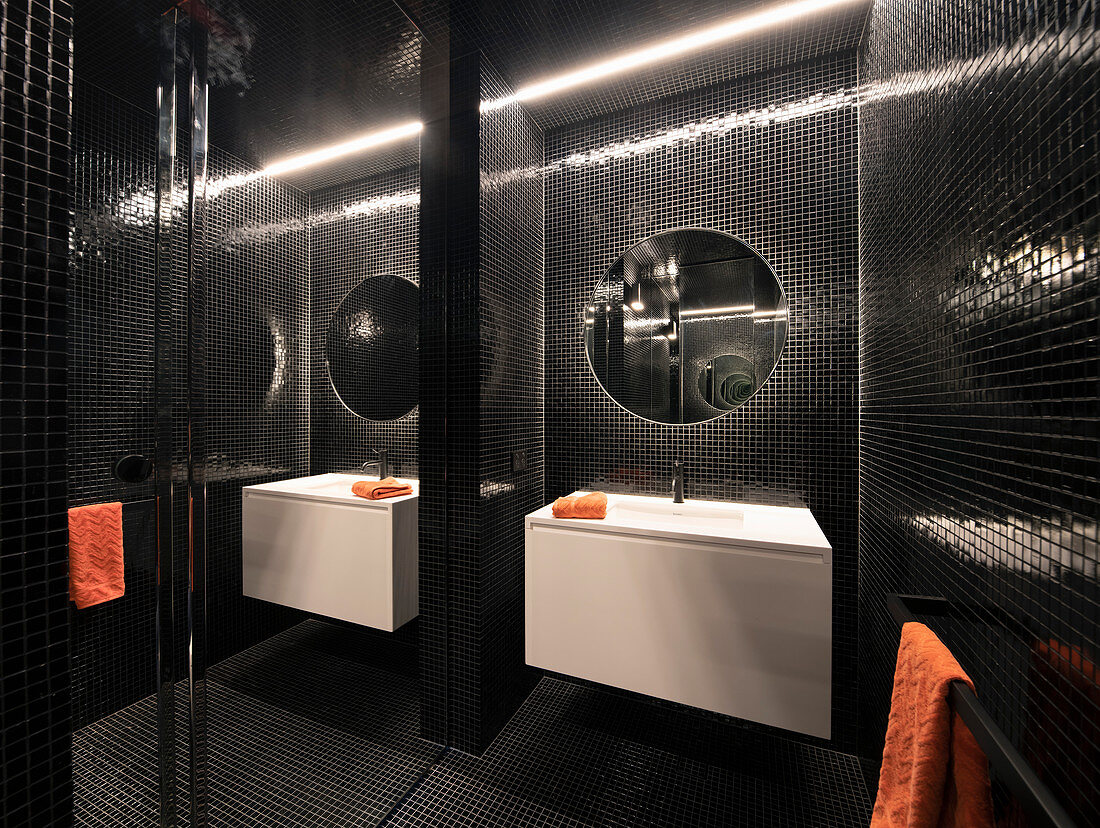 Modernes Bad mit schwarzen Mosaikfliesen und verspiegelter Wand