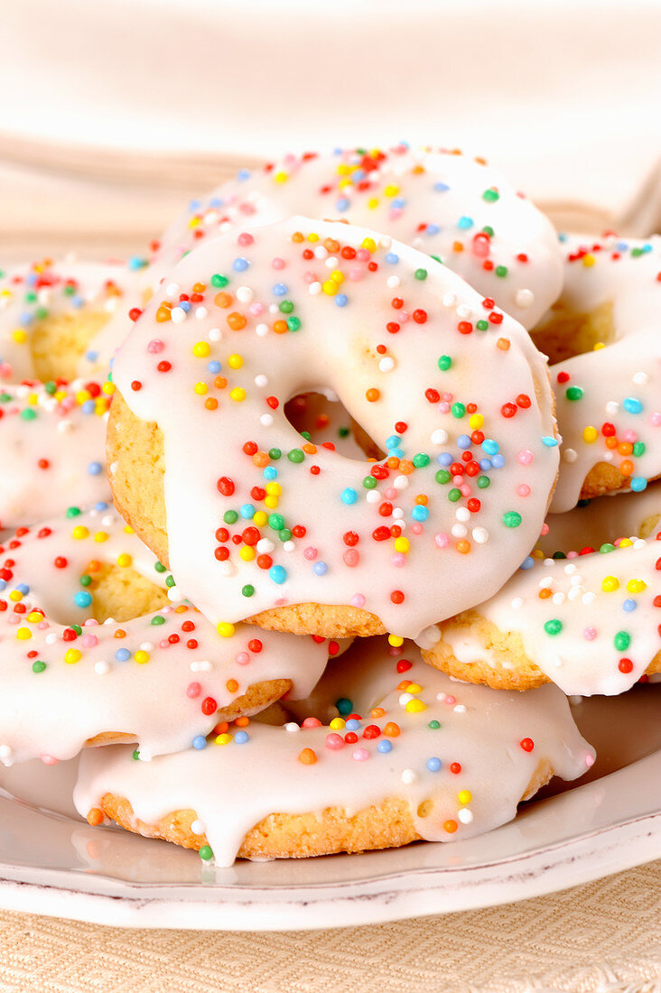 Donuts with white icing and colored pearls