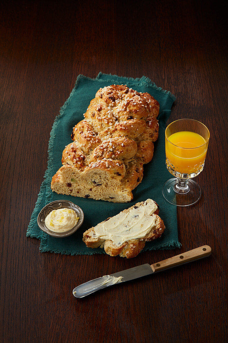 Braided yeast bread with butter, with orange juice