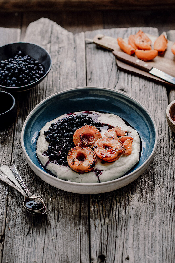 Millet pudding with blueberries and roasted apricots