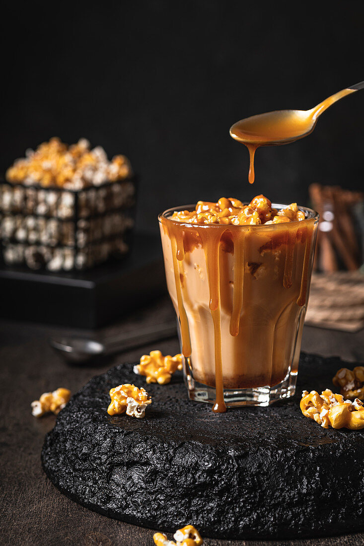Homemade coffee with caramelized popcorn and salted caramel sauce