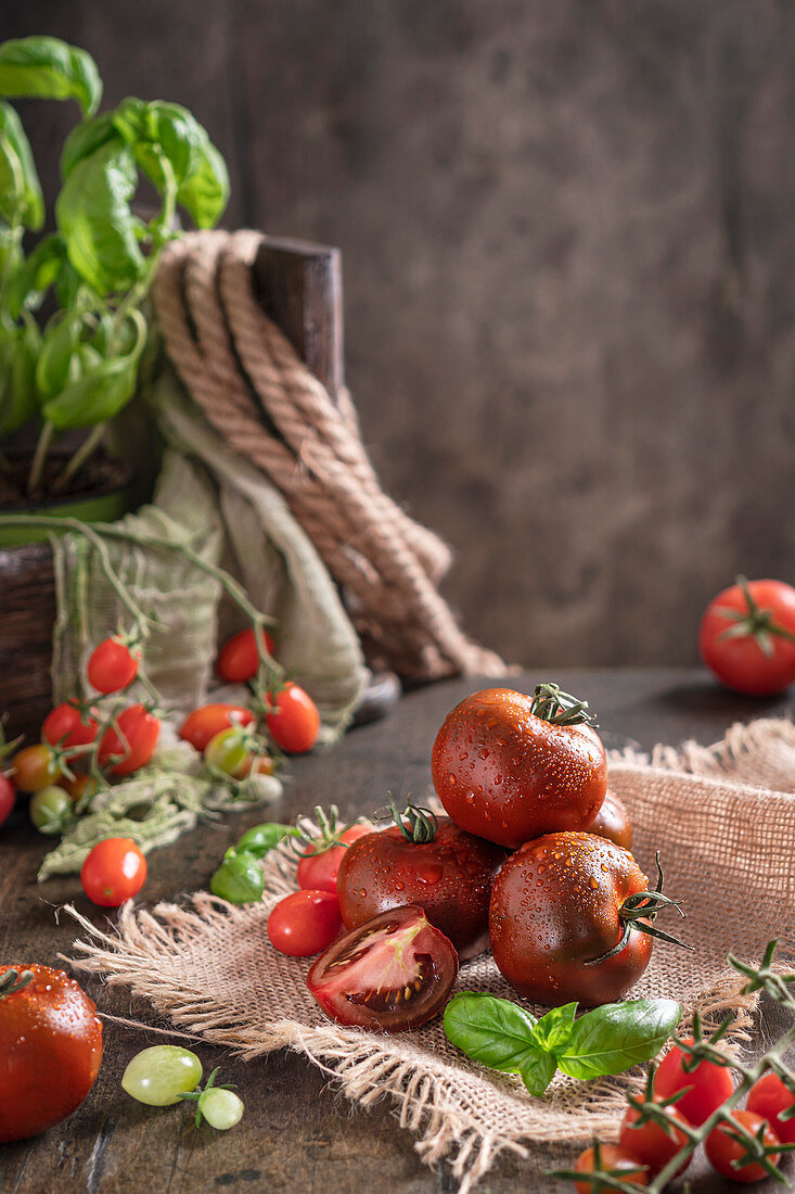 Fresh tomatoes with water drops on a wooden table