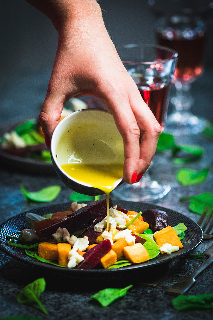 Sweet potato salad with spinach, honey, beetroot, goat cheese and walnuts