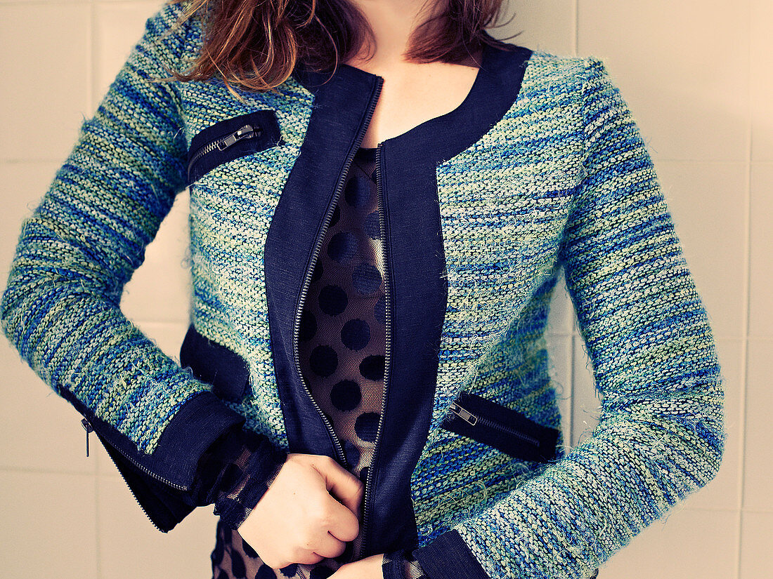 A woman wearing a cardigan with zip