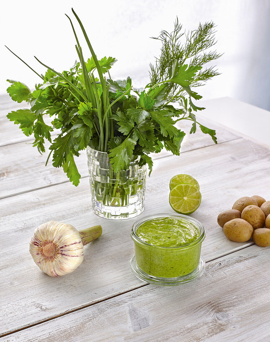 Green sauce in a bowl with various ingredients