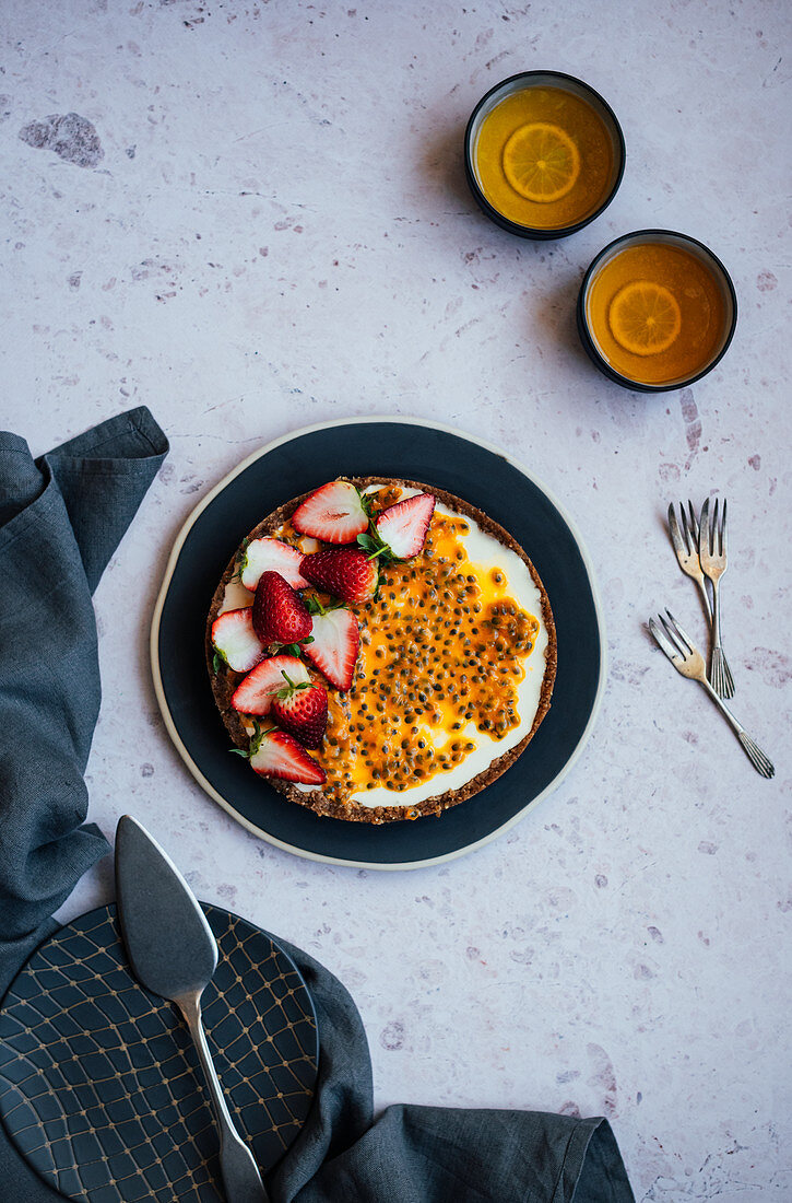Passion fruit yoghurt tart with strawberries