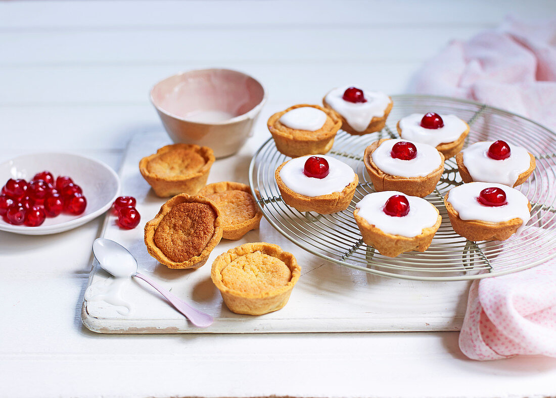 Bakewell tarts with icing and cherries