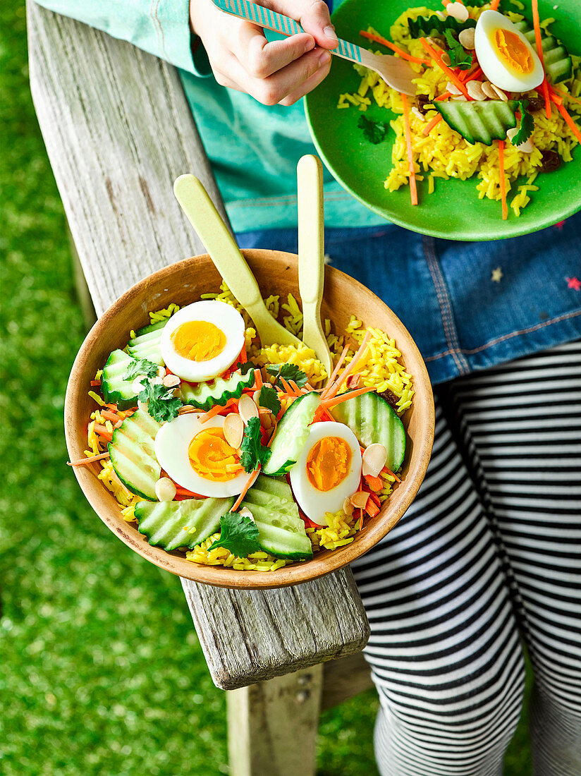 Curry rice salad with eggs and cucumber for a picnic