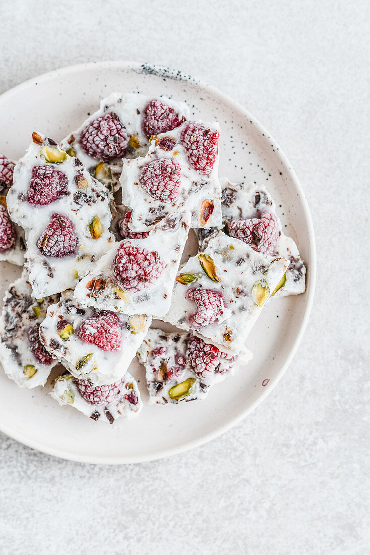 Homemade sugar-free white chocolate with raspberries and pistachios