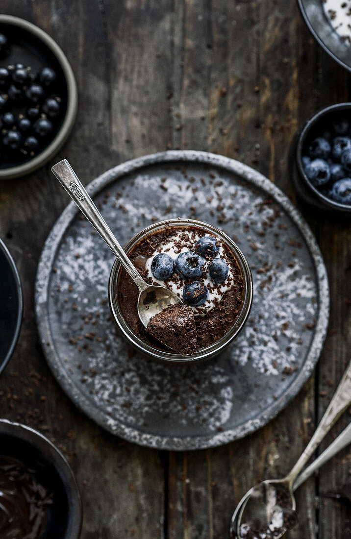 Chocolate mousse with aquafaba blueberries and black currants vegan