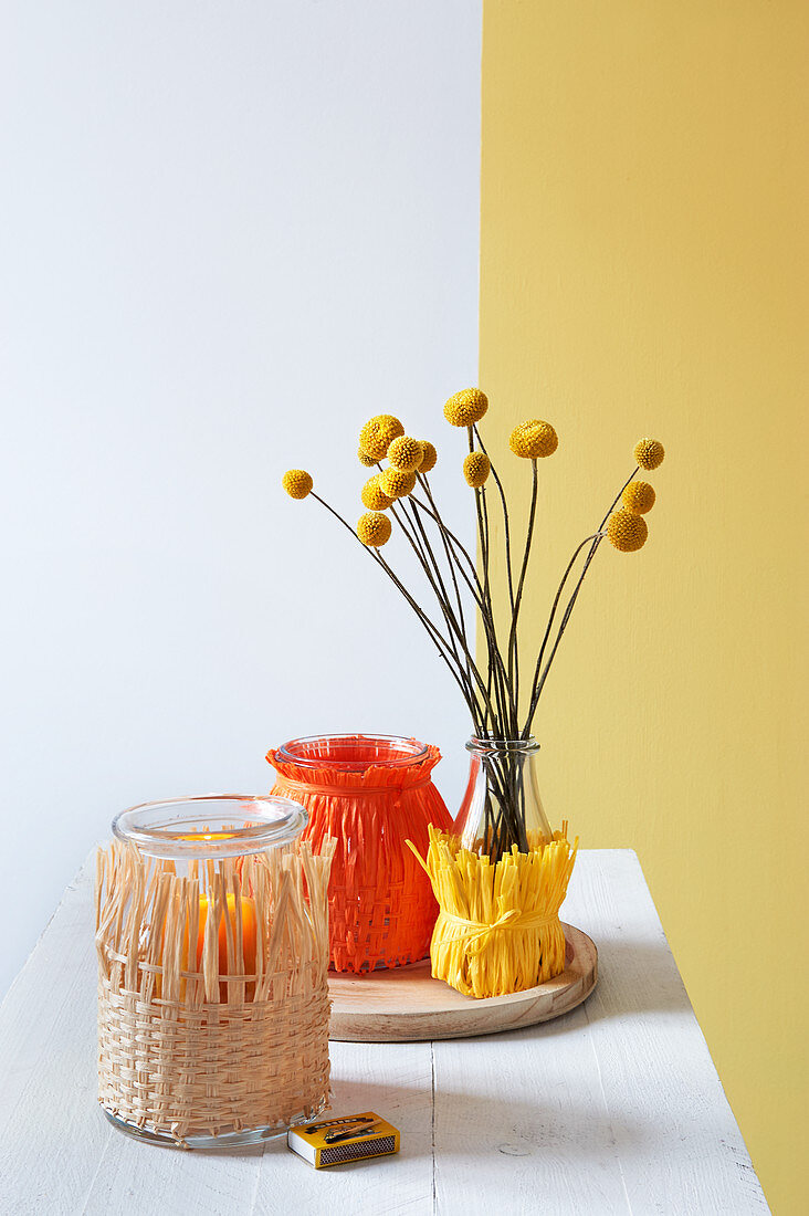 Vase and lanterns decorated with raffia
