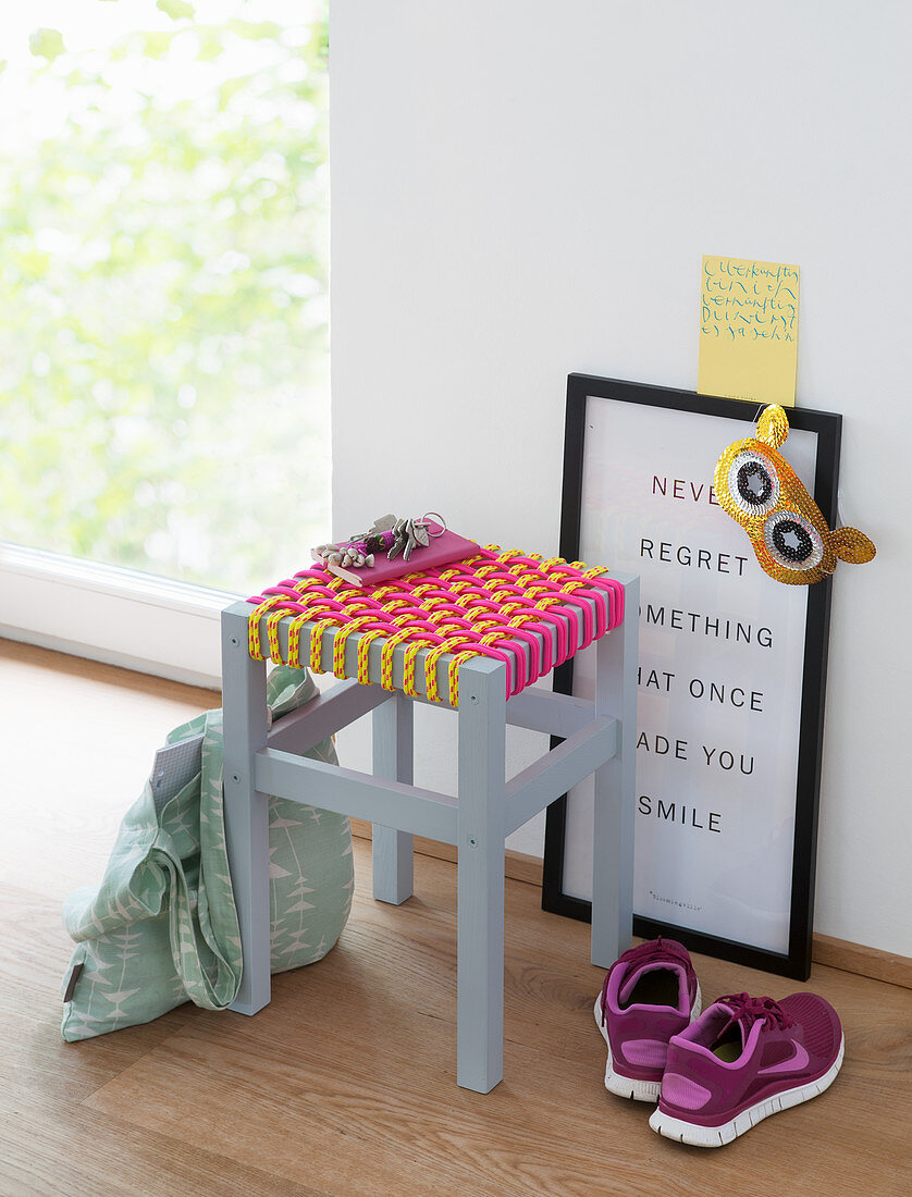 A stool with a homemade woven rope seat