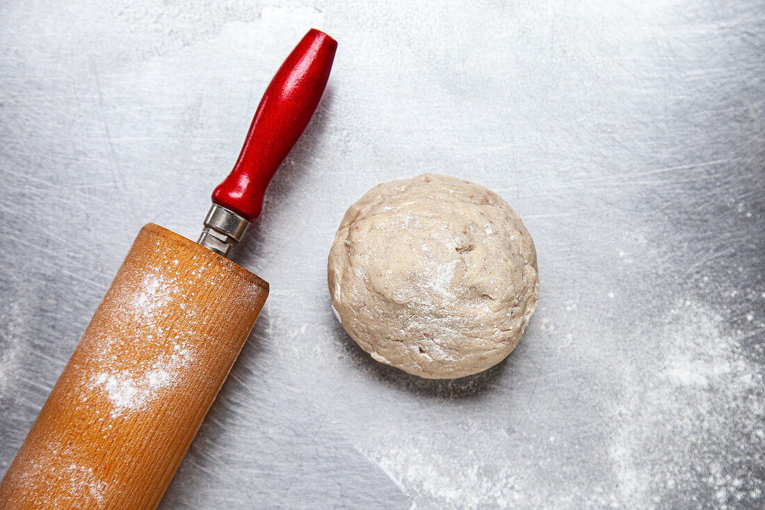 A ball of dough with a rolling pin