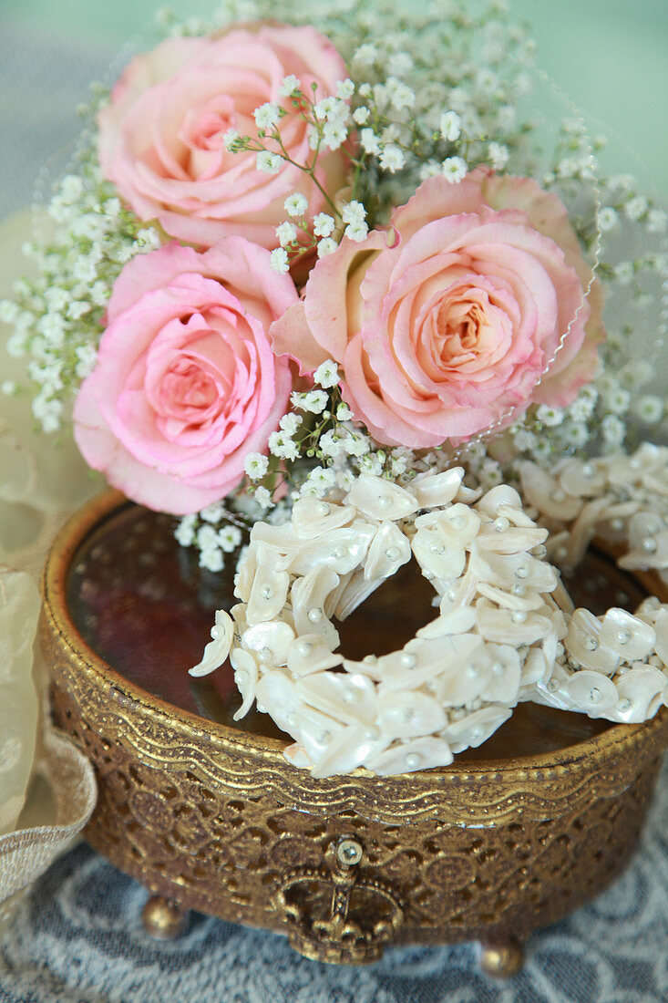 Posy of roses and gypsophila and circlet of seashells