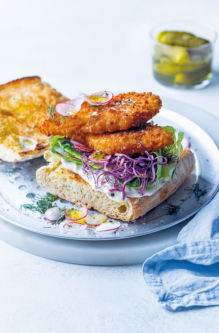 Po’ boy ciabatta sandwiches with fried hake fillets