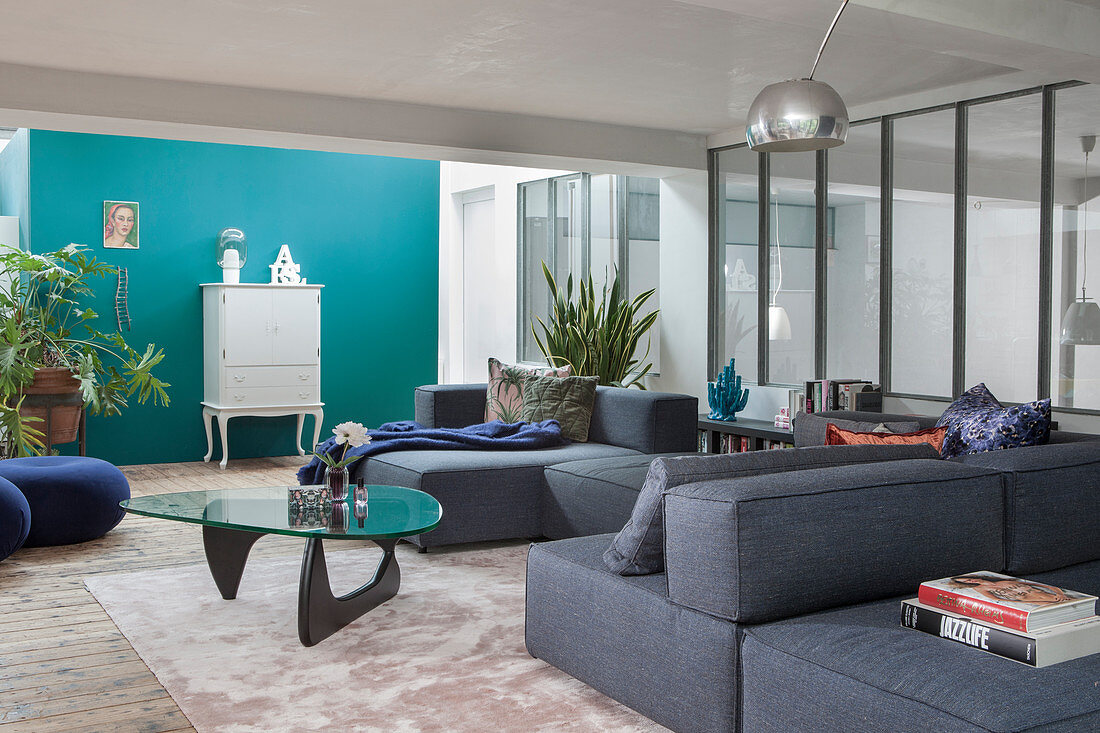 A grey upholstered suite and a coffee table in a lounge area