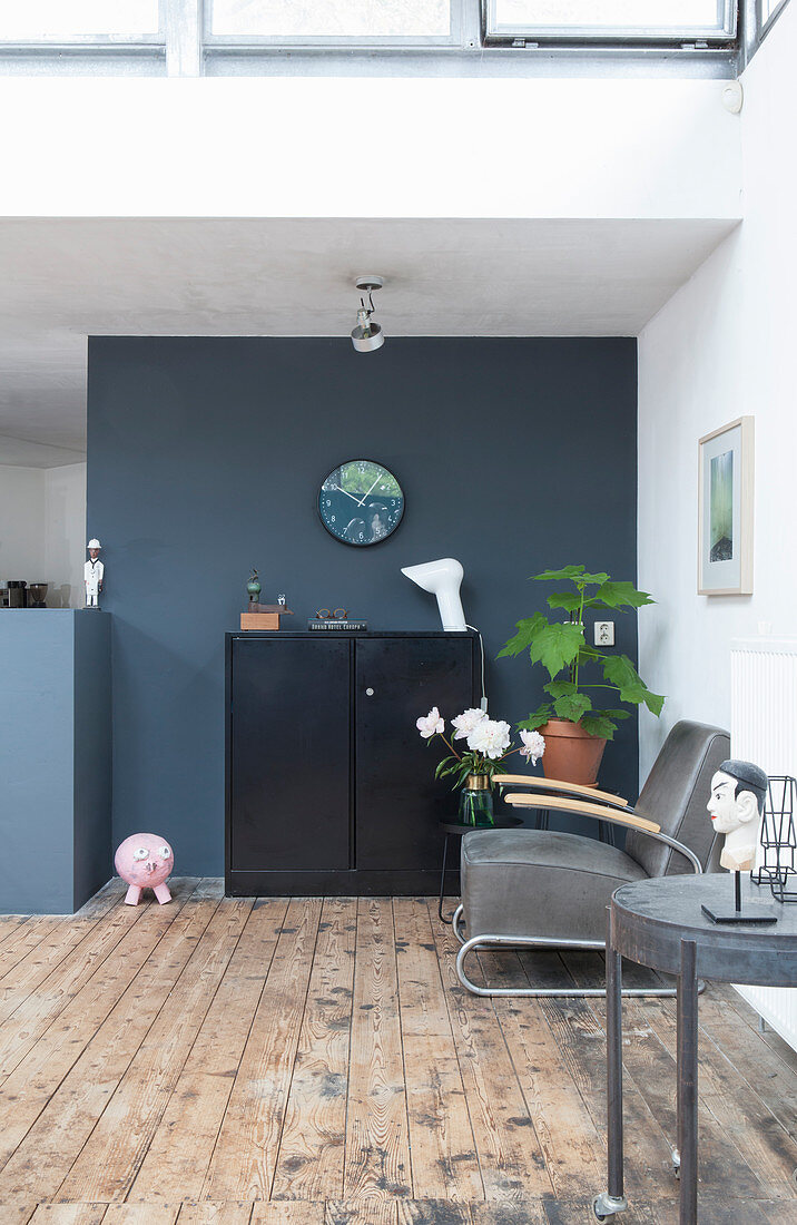 An armchair, a side table and a highboard in a loft apartment