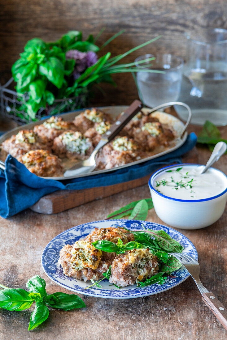 Meatballs stuffed with cheese and herbs