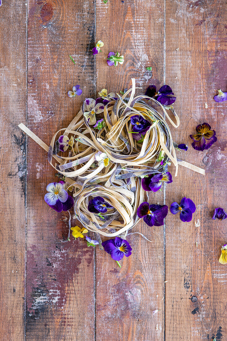 Homemade tagliatelle with edible flowers