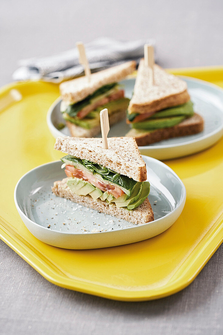 An avocado, tomato and spinach sandwich