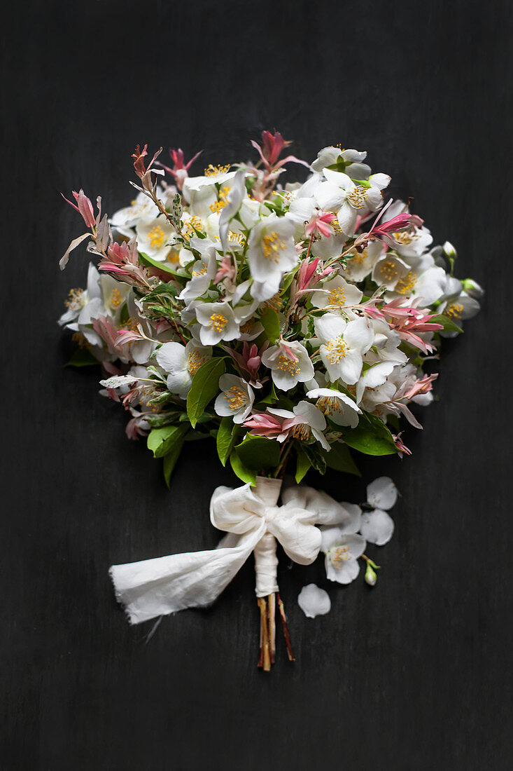 Posy of dappled willow and jasmine tied with fabric bow