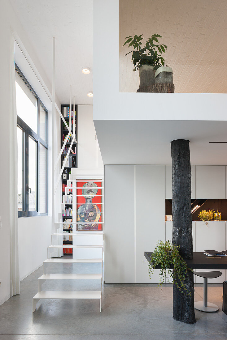 Delicate metal staircase in open-plan interior in modern building