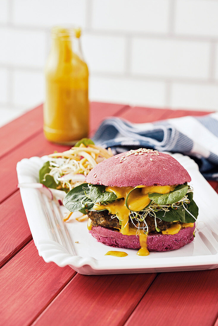 Red burger with vegan mince patties and baby spinach