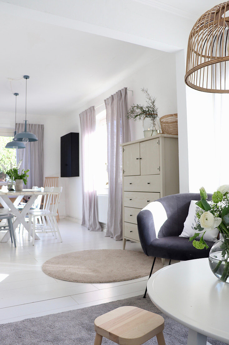 View from living room into bright dining room decorated in white and grey