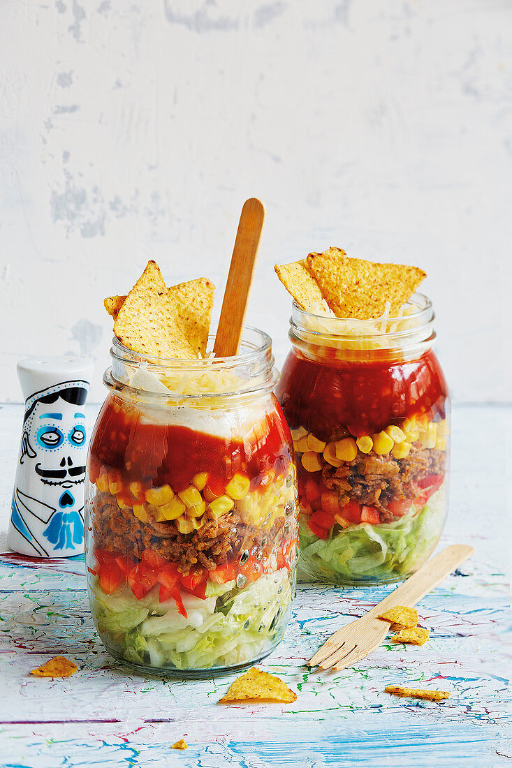 Layered taco salads in glasses (football evening)