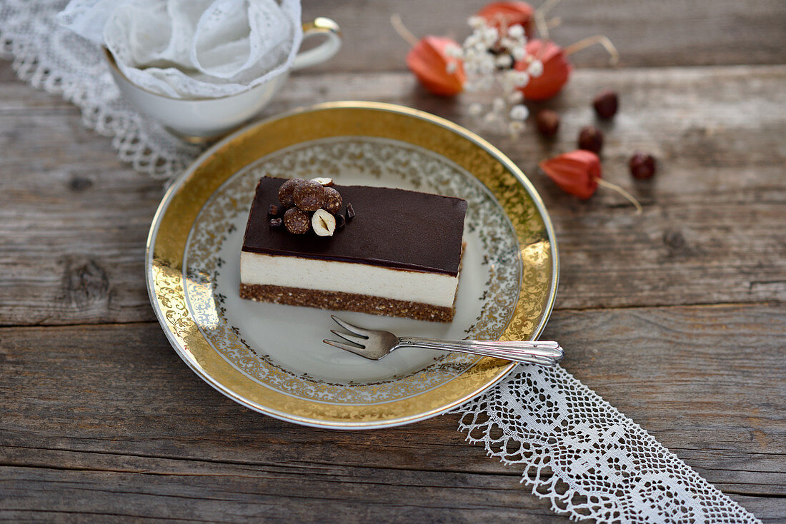 Vegan no-bake hazelnut cream slices with nut and oat date base, millet, hazelnut cream, and ganache