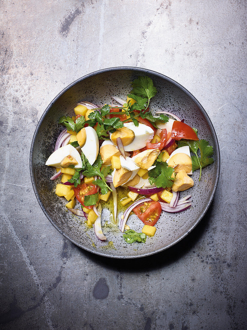 Tomato and egg salad with mango and coriander