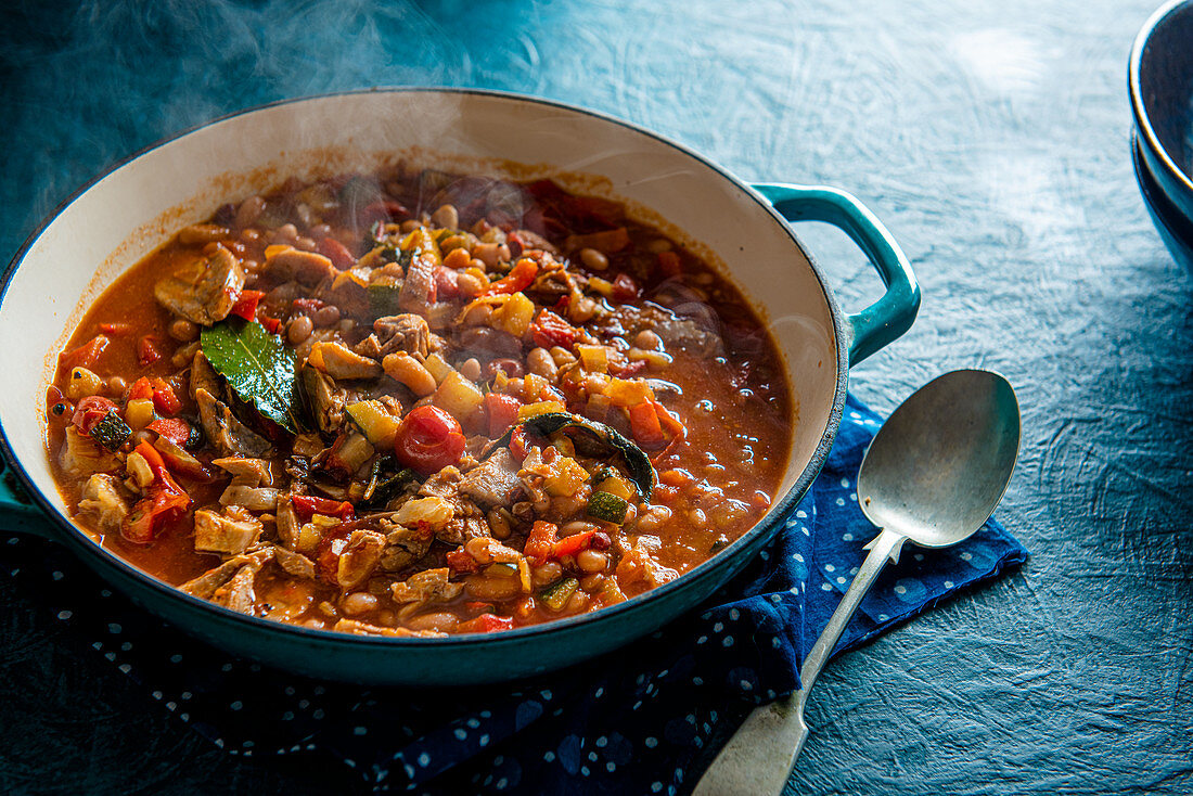 Warming pork and bean stew with tomatoes and peppers