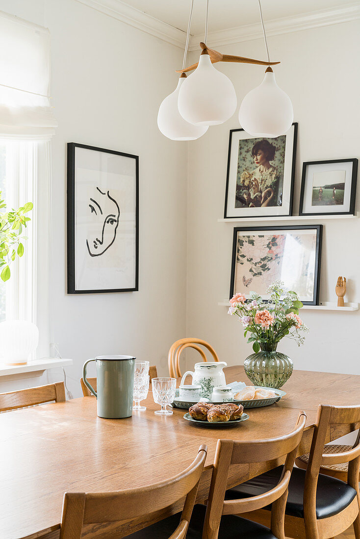 Table and chairs below pendant lamp in dining area